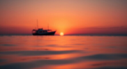 Obraz premium Softly blurred boat image on water reflecting deep orange sunset hues and gentle focus
