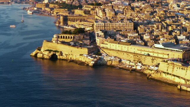 Grand Harbour In Malta. Fort Saint Angelo On The Birgu Peninsula Across Valletta At Sunrise. Aerial Shot
