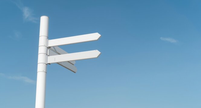 White pylon signposts with clear sky backdrop optimized for text addition