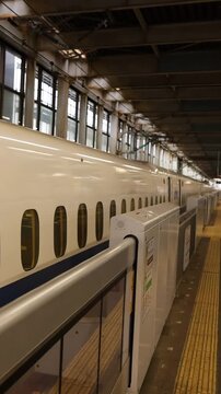 Vertical View of High Speed Bullet Train Departing Modern Railway Station