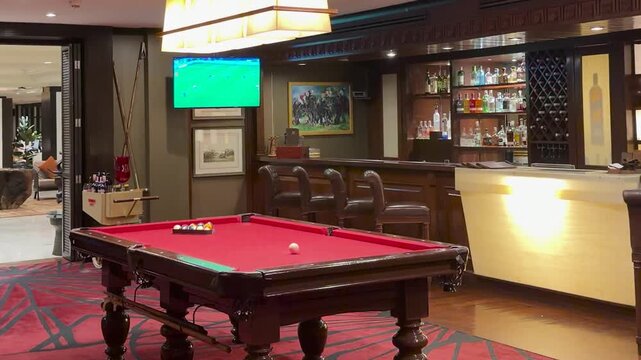 Upscale Hotel Bar Interior with Red Billiards Table and Lounge