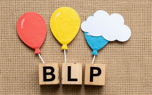 Colorful balloons float above wooden blocks spelling BLP on a