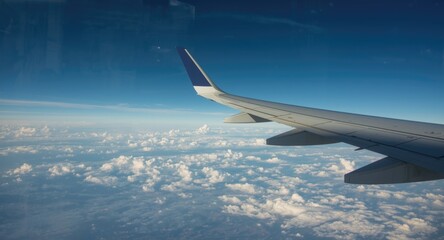 Fototapeta premium Looking outside an airplane window to see the wing in motion
