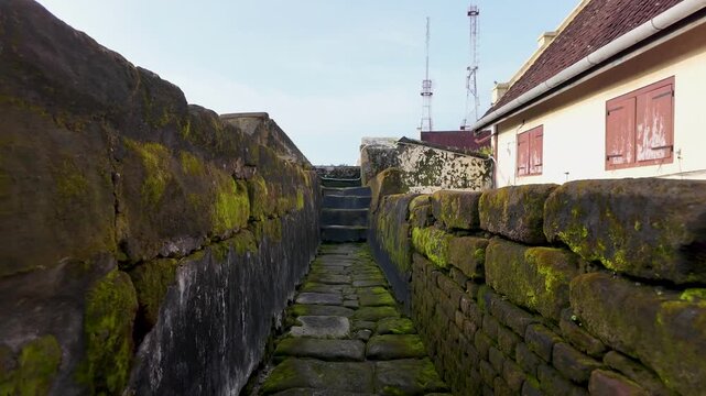 Slow motion of walking along the mossy stone path at Fort Rotterdam, Makassar City, Indonesia