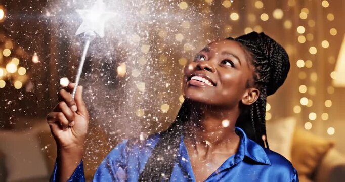 Woman in blue pajamas joyfully casting a spell with a wand amidst sparkling lights indoors