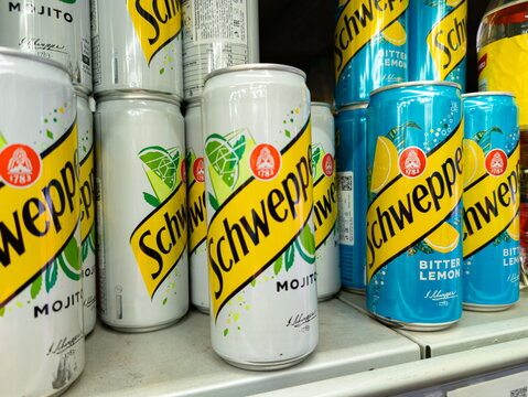 Schweppes Mojito and Bitter Lemon cans on supermarket shelf with visible branding