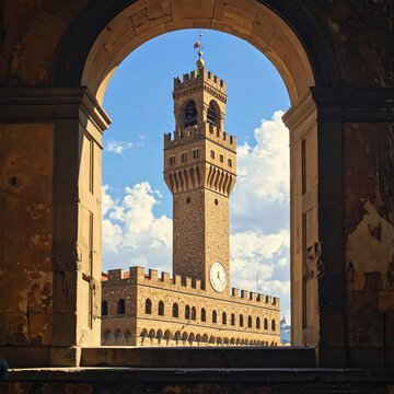 A medieval clock tower through an archway
