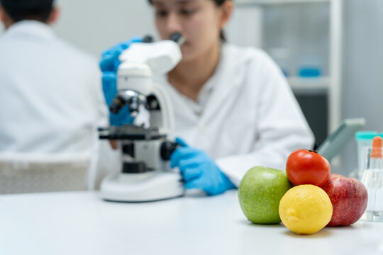 Scientist check chemical food residues in laboratory. Control experts inspect quality of fruits, vegetables. lab, hazards, ROHs, find prohibited substances, contaminate, Microscope, Microbiologist