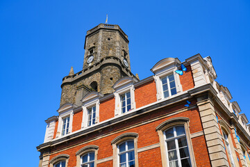 Fototapeta premium The medieval belfry and the decorated City Hall in the old town of Boulogne-sur-Mer in Pas-de-Calais, Northern France