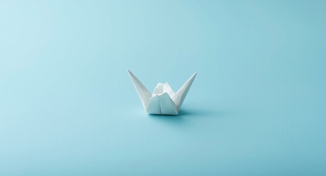 Blue textured background with white origami bird symbolizing peace and tranquility