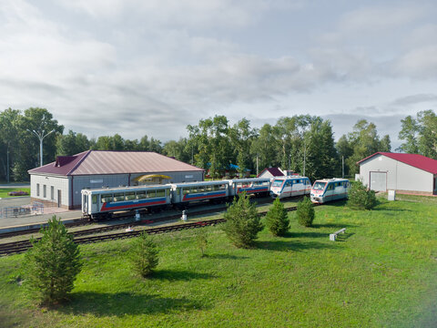 Borovskiy, Russia - August 6, 2021: High-angle drone shot of Yunost station (Yunost Railway Station), the main station of the Tyumen Children's Railway (Malaya Tyumenskaya Railway) near Borovsky