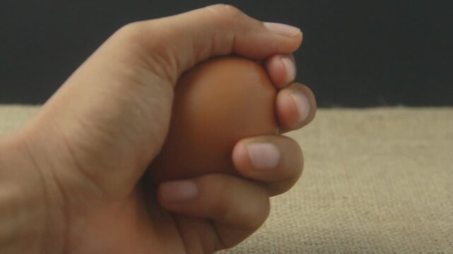 Rustic still-life photograph featuring fresh brown chicken eggs resting on a textured burlap (hessian) cloth. The composition emphasizes a "farm-to-table" aesthetic with its natural tones and organic 