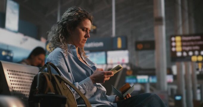 Woman Sits in International Airport Terminal, Using Smartphone Scan QR Code on Boarding Pass. Female Verifies Flight Data While Enjoying Cup of Coffee. Concept of Paperless Travel, Digital Check In.