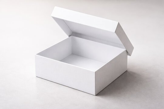Close up of a white box with open lid on a smooth surface