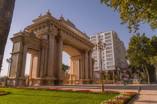 Entrance to Istiklol Park in Dushanbe, Tajikistan, invites visitors into green oasis amid Central Asian urban life and Soviet-era architecture. 
