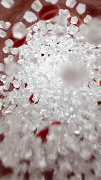 Blood sugar spike visualization medical concept macro texture of granulated crystal glucose red liquid artery vessel interior with red blood cell flow atherosclerosis plaque for diabetes sweetener