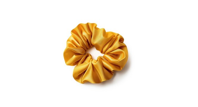 Luxurious yellow satin scrunchie hair accessory seen from above on white background