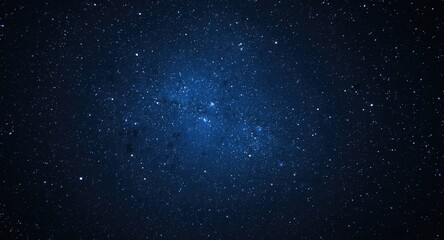 Fototapeta premium twinkling stars glowing in a deep blue and black celestial expanse