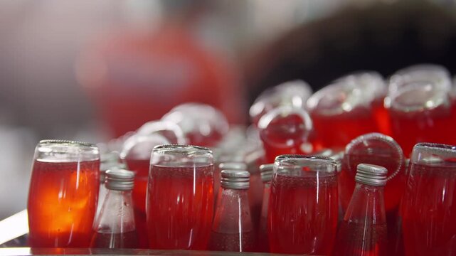 Ruby Beverage Array: A captivating close-up presents an organized row of glass containers filled with a vibrant ruby-hued beverage. The scene evokes a sense of refreshing clarity.