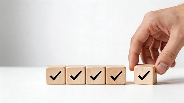 Hand placing wooden block with checkmark symbol on white background concept of approval success quality control completing tasks positive feedback and making the right choice in