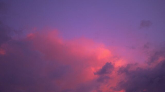 scenery pink cloud in purple sky of sunset above the ocean. 
purple clouds cover the ocean during colorful cloud in sunset at Kata beach Phuket.
video 4K. Scene of pink light in the sky background.