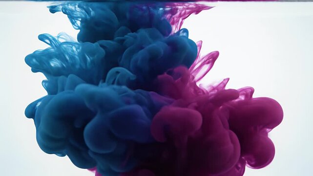 Abstract swirls of deep blue and vibrant purple ink dissolve in clear liquid