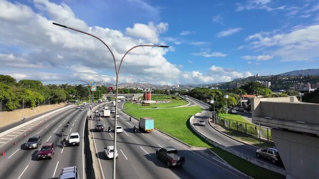Pan left over the Autopista Francisco Fajardo towards Petare cityscape