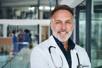 Fototapeta premium Man, doctor and smile with portrait in clinic lobby for career pride, about us and healthcare. Hospital, person and ambition for medical support, cardiology surgeon and confidence for wellness