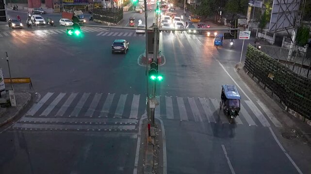 Busy Indian city traffic intersection timelapse with vehicles, auto rickshaws and red signal lights