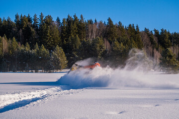 Athlete on a snowmobile moving in the winter forest in the mountains of the Southern Urals