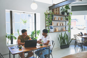 Fototapeta premium Talking, laptop and team with men in coffee shop for small businesses venture, entrepreneur and email. Online rating, meeting and restaurant review with people in cafe for planning and remote work