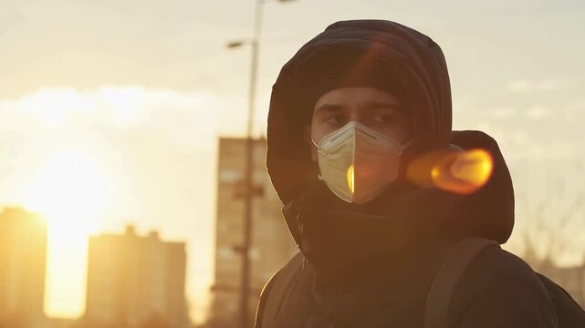Protected in the Sunlight: A person wearing a protective face mask looks directly at the camera, conveying the serious atmosphere of the pandemic. Capturing the essence of concern for health.