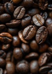 Fototapeta premium Close up of frame filled with roasted coffee beans in shades of brown.