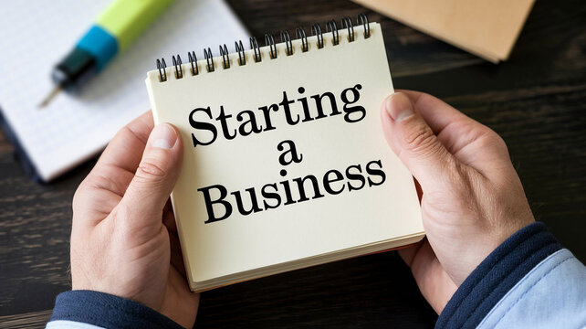 Hands Holding Notepad with Starting a Business Text for Entrepreneurship and New Venture Planning Images