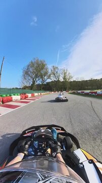 Racing a Go Kart vertical video helmet point of view