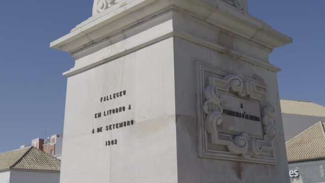 View of the Monument to Ferreira de Almeida, a historic statue in Faro&rsquo;s cityscape.