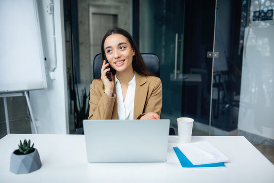 Female office worker, manager consulting client over the phone offer services with smile