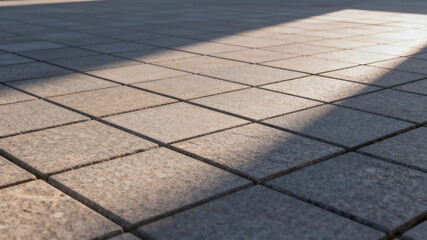 Fototapeta premium Sunlit Paved Tiles with Shadow Patterns