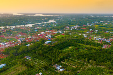 Aerial view of Phu Son village of bougainvillea blooms throughout Ben Tre, Vietnam © CravenA
