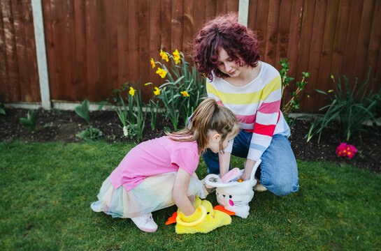 Easter hunt. Kids having fun and picking easter eggs, spring garden