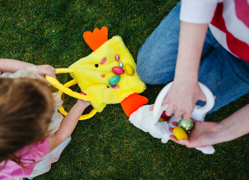 Easter hunt. Kids having fun and picking easter eggs, spring garden