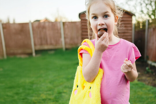 Child eating a chocolate egg, easter hunt