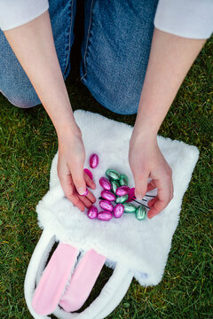Teen age girl finding hidden Easter eggs at home