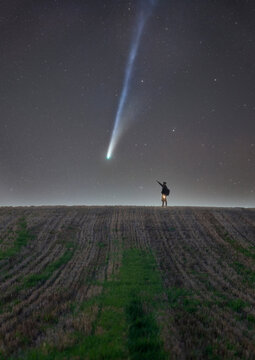 Night Sky Man Silhouette Pointing at Interstellar Comet Lemmon