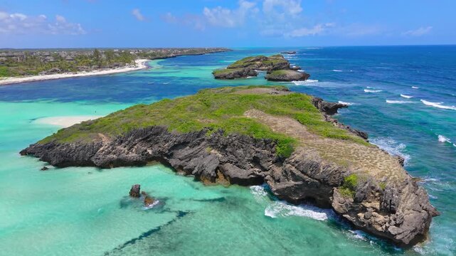 Aerial view of rocky islands and turquoise coral reefs along the coastline with white sand beaches at Watamu Beach, Kenya.