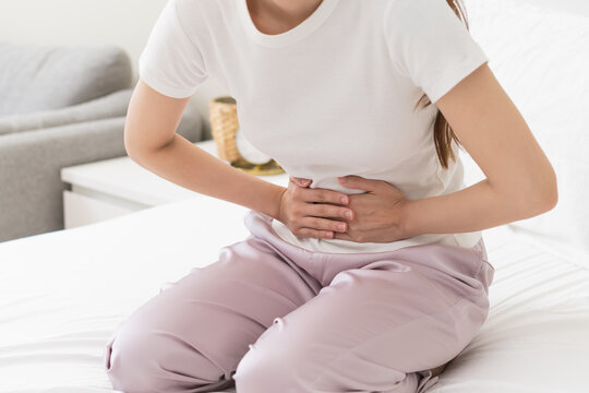 Flatulence ulcer, asian young woman, girl hands in belly, stomach pain from food poisoning, abdominal pain and digestive problem, gastritis or diarrhoea. Abdomen inflammation, menstrual period people.