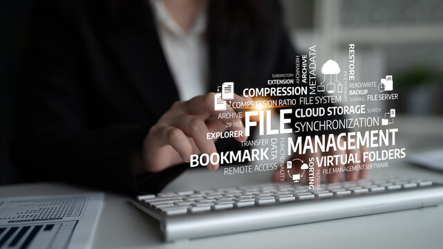 A professional uses a keyboard to manage files and explore cloud storage tools, highlighting important concepts in digital organization and productivity in a modern office. Tessel