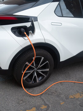 Toyota C HR plug in hybrid electric car charging, connecting to power, e mobility and sustainable transport