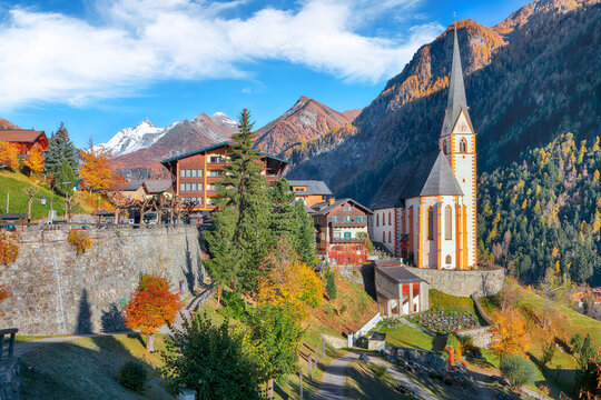Astonishing autumn landscape  at Heiligenblut with St Vincent Church near Grossglockner mount .