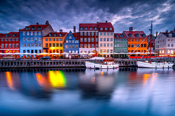 Fototapeta premium Traditional colorful architecture of Nyhavn in Copenhagen at dawn with boats, Denmark. Postcard from Scandinavia.